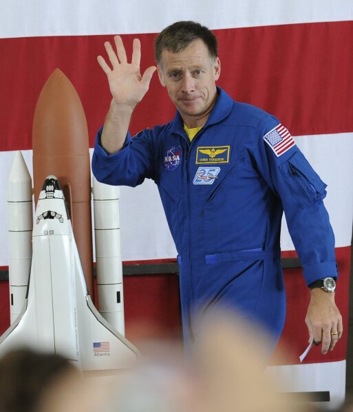 FILE - In this Friday, July 22, 2011 file photo, space shuttle commander Chris Ferguson waves to the crowd at the welcome home ceremony for the astronauts of the final shuttle mission in Houston. On Wednesday, Oct. 7, 2020, Ferguson removed himself from the first Boeing crew, citing his daughter’s wedding in 2021. He has been replaced on the Starliner crew by Butch Wilmore. (AP Photo/Pat Sullivan)