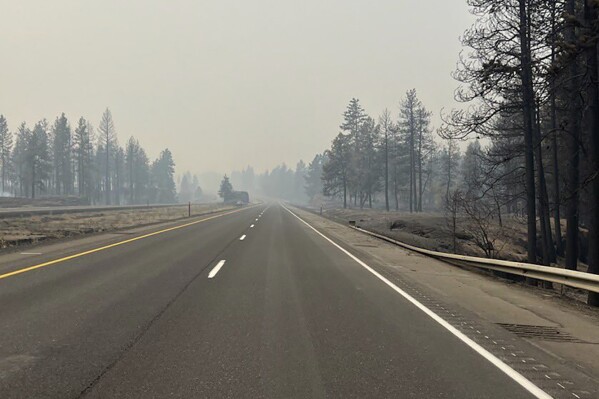 FILE - In this photo provided by WSDOT East (Washington State of Transportation), smoke from wildfires fill the sky at Salnave/SR 902 interchange in Spokane County, Wash., on Saturday, Aug. 19, 2023. Authorities say a second person has died in wildfires in eastern Washington state that sparked Friday, burning hundreds of structures and closing a section of a major interstate. Fire officials said Monday, Aug. 21, a body was found in the area of the Oregon fire north of Spokane on Sunday. (WSDOT East via AP, File)
