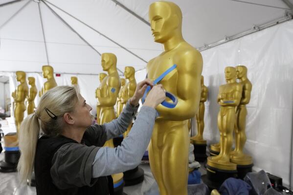 Antje Menikheim, lead scenic painter for Sunday's 95th Academy Awards, readies an Oscar statue for the event, Wednesday, March 8, 2023, near the Dolby Theatre in Los Angeles. (AP Photo/Chris Pizzello)