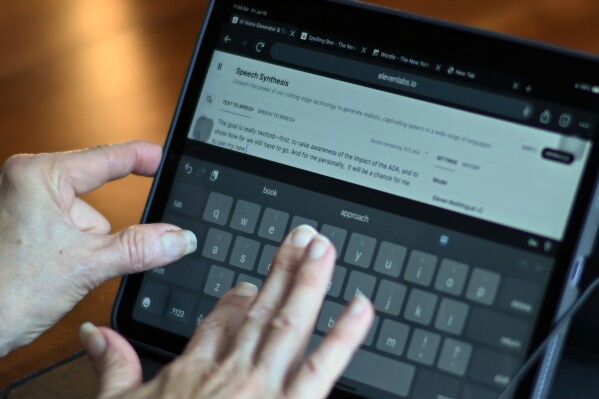 Rep. Jennifer Wexton, D-Va., uses an AI program on her iPad at her home in Leesburg, Va., Friday, July 19, 2024. A rare neurological disease robbed Wexton of her ability to speak clearly. But with the help of a powerful artificial intelligence program, the Virginia Democrat will use a clone of her voice to deliver what is believed to be the first speech on the House floor ever given via a voice cloned by artificial intelligence, thrusting Wexton into a broader debate about over artificial intelligence. (AP Photo/John McDonnell)