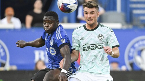 CF Montreal's Sunusi Ibrahim, left, defends against Atlanta United's Amar Sejdic during the first half of an MLS soccer match Saturday, July 8, 2023, in Montreal. (Graham Hughes/The Canadian Press via AP)