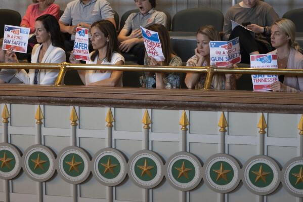 Members of Voices for a Safer Tennessee hold signs as they attend a Senate legislative session at the state Capitol, Thursday, April 20, 2023 in Nashville, Tenn. The group is advocating for gun-control laws following the Covenant School Shooting that happened March 27. (AP Photo/George Walker IV)