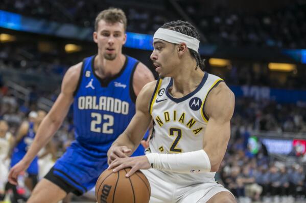Indiana Pacers guard Andrew Nembhard (2) drives against Orlando Magic forward Franz Wagner (22) during the first half of an NBA basketball game Saturday, Feb. 25, 2023, in Orlando, Fla. (AP Photo/Alan Youngblood)