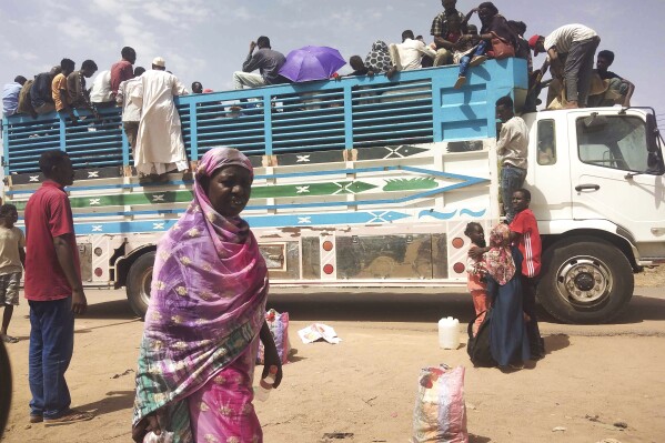 FILE - People board a truck as they leave Khartoum, Sudan, on June 19, 2023. A leading human rights group called Friday Aug.4, 2023 on the United States and the United Nations to impose further sanctions on the Sudanese individuals "responsible for the atrocities" in Darfur, as evidence of scorched-earth attacks mount. The northeast African country plunged into chaos in April when monthslong tensions between the military, led by Abdel Fattah Burhan, and the paramilitary Rapid Support Forces, commanded by Mohammed Hamdan Dagalo, exploded into open fighting in the capital of Khartoum, and elsewhere. (AP Photo, File)