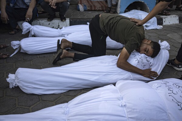 Palestinians mourn their relatives killed in the Israeli bombardment of the Gaza Strip in front of the morgue in Deir al Balah, Wednesday, Nov. 1, 2023. ( AP Photo/Fatima Shbair)