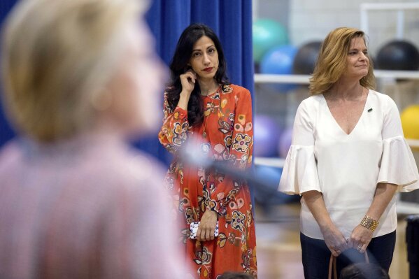 
              FILE - In this Thursday, Sept. 15, 2016 file photo, senior aide Huma Abedin, center, and Director of Communications Jennifer Palmieri, right, stand nearby as Democratic presidential candidate Hillary Clinton answers a question after a rally in Greensboro, N.C. On the 22nd, 23rd and 25th of March 2016, three volleys of malicious messages were generated targeting Abedin and Palmieri, among many others. (AP Photo/Andrew Harnik)
            