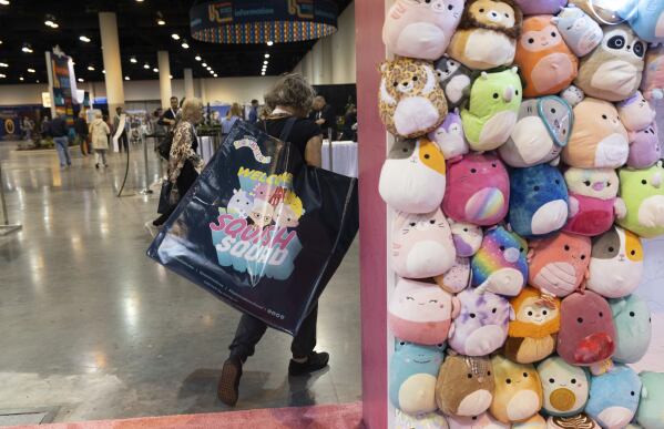 FILE - A shareholder leaves the Squishmallows booth with a large bag of purchases in the exhibition hall of the Berkshire Hathaway annual meeting on Saturday, May 6, 2023, in Omaha, Neb. A judge in New York has ruled that Alibaba must face a lawsuit by a U.S. toymaker alleging that the Chinese ecommerce giant’s online platforms were used to sell counterfeit Squishmallows. (AP Photo/Rebecca S. Gratz, File)