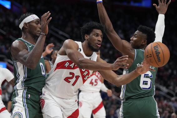 Toronto Raptors forward Thaddeus Young (21) passes the ball as Detroit Pistons center Jalen Duren (0) defends during the second half of an NBA basketball game, Monday, Nov. 14, 2022, in Detroit. (AP Photo/Carlos Osorio)