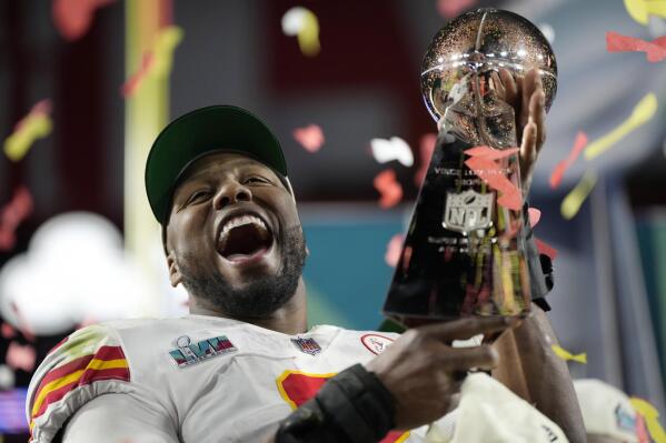 Kansas City Chiefs defensive end Carlos Dunlap celebrates with the Vince Lombardi Trophy after the NFL Super Bowl 57 football game, Sunday, Feb. 12, 2023, in Glendale, Ariz. The Kansas City Chiefs defeated the Philadelphia Eagles 38-35. (AP Photo/Ashley Landis)