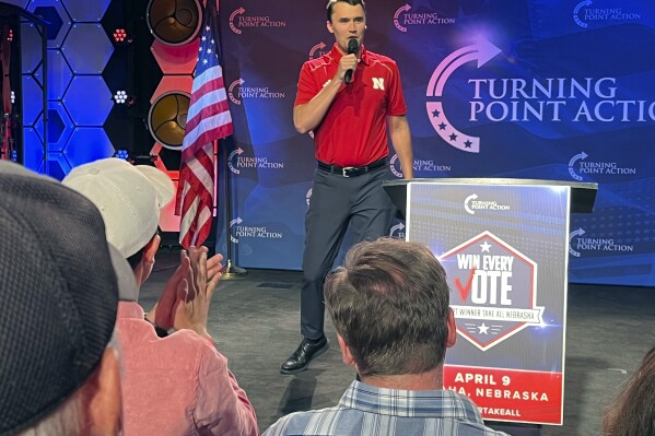 Conservative activist Charlie Kirk takes the stage before a rally held by the Nebraska Republican Party calling on Nebraska to switch to a winner-take-all method of awarding Electoral College votes ahead of this year's hotly contested presidential election, Tuesday, April 9, 2024, in Omaha, Neb. Nebraska has five presidential electoral votes, but allows the votes tied to its three congressional districts to be split based on the popular vote within each district. Maine is the only other state to split its electoral votes. (AP Photo/Margery Beck)