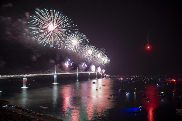 Fireworks illuminate skies over the newly built Peljesac Bridge in Komarna, southern Croatia, Tuesday, July 26, 2022. Croatia is marking the opening of a key and long-awaited bridge connecting two parts of the country's Adriatic Sea coastline while bypassing a small part of Bosnia's territory. (AP Photo)