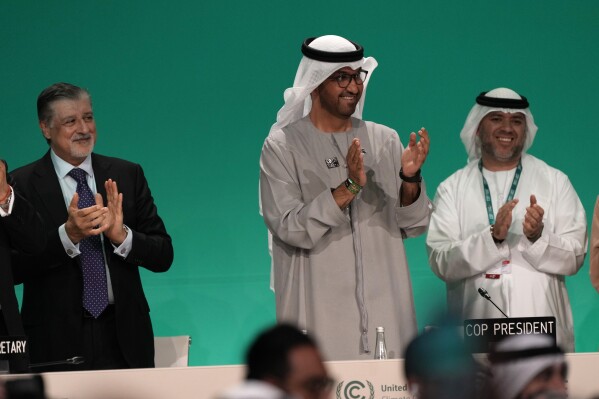 COP28 President Sultan al-Jaber, center, claps after passing the global stocktake at the COP28 U.N. Climate Summit, Wednesday, Dec. 13, 2023, in Dubai, United Arab Emirates. (AP Photo/Kamran Jebreili)