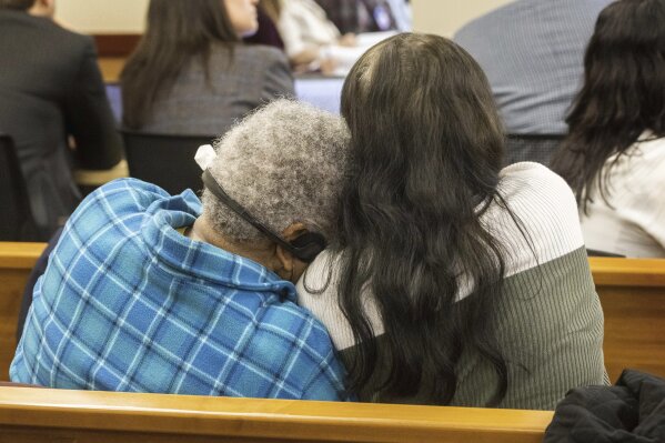 Women embrace as a video is shown during the trial of three Washington officers accused in the death of Manny Ellis in Pierce County Superior Court in Tacoma, Wash., Wednesday, Oct. 4, 2023. (Ellen Banner/The Seattle Times via AP, Pool)