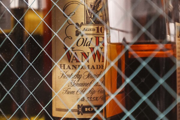 FILE - A bottle of Old Pappy Van Winkle bourbon, a 10-year-old, is shown behind glass doors at a whiskey bar, Saturday, March 4, 2023. (AP Photo/Damian Dovarganes, File)