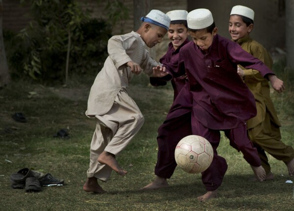 FILE - Boys play soccer during a break at their school in Kandahar, southern Afghanistan, Oct 29, 2013. (AP Photo/Anja Niedringhaus, File)