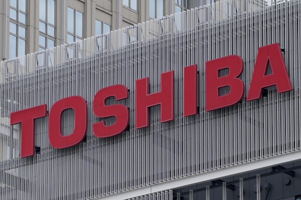 FILE - The logo of Toshiba Corp. is seen at a company's building in Kawasaki near Tokyo, on Feb. 19, 2022. Toshiba announced a 2 trillion yen ($14 billion) tender offer on Monday, Aug. 7, 2023, in a move that will take it private, as the scandal-tarnished Japanese electronics and energy giant seeks to turn itself around. (AP Photo/Shuji Kajiyama, File)