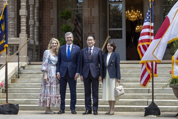 North Carolina first lady Kristin Cooper, North Carolina Gov. Roy Copper, Japan Prime Minister Fumio Kishida and Japan first lady Yuko Kishida pose for a photograph before attending a luncheon at the North Carolina Executive Mansion, Friday, April 12, 2024, in Raleigh, N.C. (Robert Willett/The News & Observer via AP, Pool)