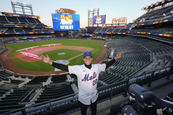 New York Mets' Juan Soto poses for photographs at Citi Field, Thursday, Dec. 12, 2024, in New York. (AP Photo/Frank Franklin II)