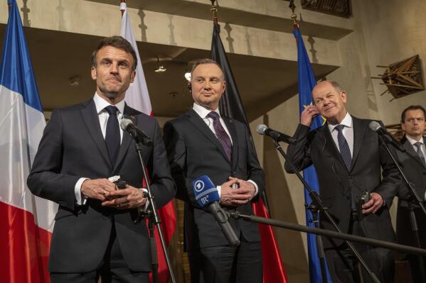 From left, French President Emmanuel Macron, Polish President Andrzej Duda and German Chancellor Olaf Scholz (SPD) make a joint press statement on the sidelines of the Security Conference in Munich, Friday Feb. 17, 2023. The 59th Munich Security Conference (MSC) will take place from February 17 to 19, 2023, at the Bayerischer Hof Hotel in Munich. (Peter Kneffel/dpa via AP)