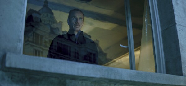 This image released by Netflix shows Michael Fassbender as an assassin in a scene from "The Killer." (Netflix via AP)