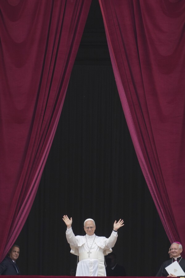 Pope Leo XIV appears at the central balcony of St. Peter's Basilica for his first Sunday blessing after his election, in St. Peter's Square at the Vatican, Sunday, May 11, 2025. (AP Photo/Andrew Medichini)