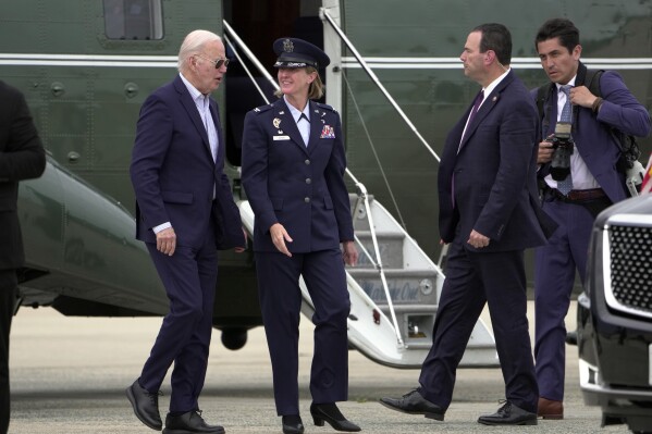 President Joe Biden talks with Air Force Col. Angela Ochoa, Commander, 89th Airlift Wing, as he arrives at Andrews Air Force Base, Md., on Marine One Monday, June 10, 2024. (AP Photo/Manuel Balce Ceneta)