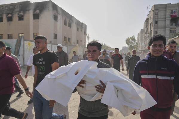 Palestinians carry the bodies of those who were killed in an overnight Israeli airstrike, during their funeral in Khan Younis, Gaza Strip, Sunday, May 11, 2025. (AP Photo/Abdel Kareem Hana)