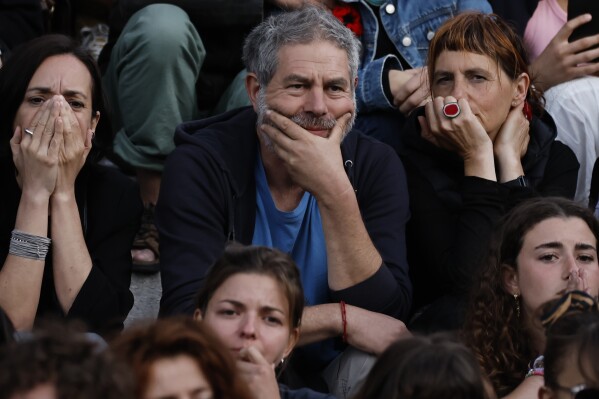 Other folks count on the implications of the 2nd spherical of the legislative elections, Sunday, July 7, 2024 in Nantes, western France. Vote casting is underway in mainland France on Sunday in pivotal runoff elections that can maybe maybe hand a historic victory to Marine Le Pen's some distance-correct National Rally and its inward-attempting, anti-immigrant vision, or agree with a hung parliament and political impasse. (AP Photo/Jeremias Gonzalez)