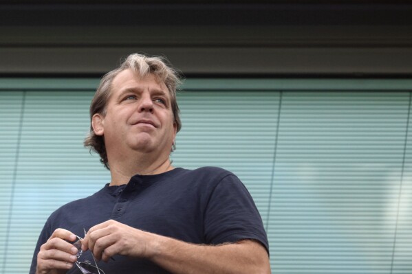 FILE - Chelsea owner Todd Boehly looks out from the stands before the English Premier League soccer match between Chelsea and Leicester City at Stamford Bridge Stadium in London, Saturday, Aug. 27, 2022. After a year of chaos in Todd Boehly’s first full season as owner, can the arrival of Mauricio Pochettino and the severe trimming of the squad restore enough order at a club used to winning trophies? (AP Photo/David Cliff, File)