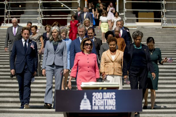 House Speaker Nancy Pelosi of Calif. and House Democrats arrive for a news conference on the first 200 days of the 116th Congress at the House East Front steps of the Capitol building, in Washington, Thursday, July 25, 2019. (AP Photo/Andrew Harnik)