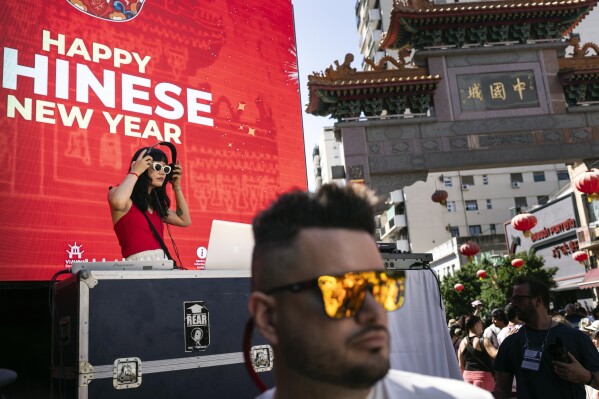 A disc jockey plays music during the Chinese New Year celebrations, marking the year of the snake, in Buenos Aires, Argentina, Saturday, Jan. 25, 2025. (AP Photo/Rodrigo Abd)