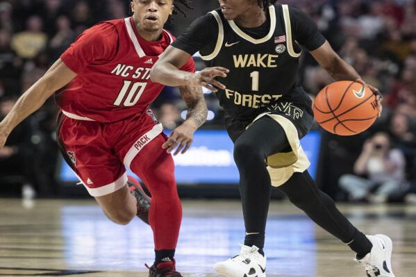 Wake Forest guard Tyree Appleby (1) moves around the defense of North Carolina State guard Breon Pass (10) in the first half of an NCAA college basketball game on Saturday, Jan. 28, 2023, in Winston-Salem, N.C. (Allison Lee Isley/The Winston-Salem Journal via AP)