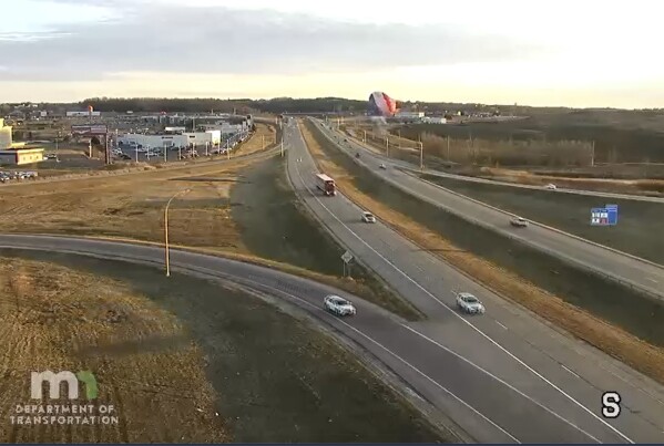 This photo provided by Minnesota Department of Transportation shows a hot air balloon crashing into a power lin in Rochester, Minn., on Wednesday, March 20, 2024. Two people suffered minor injuries as authorities say the basket detached from the balloon and fell about 20 to 30 feet to the ground. (Minnesota Department of Transportation)