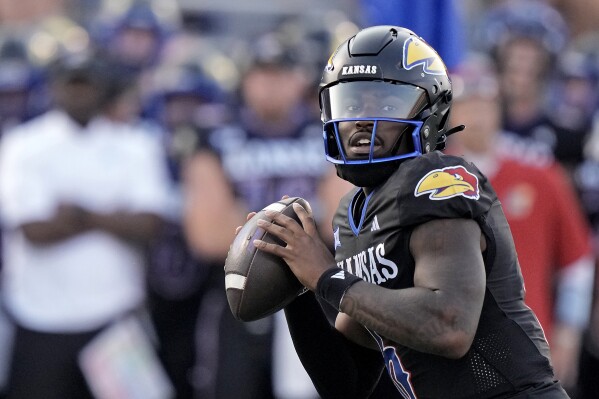 Kansas quarterback Jalon Daniels looks to pass during the first half of an NCAA college football game against the Illinois Friday, Sept. 8, 2023, in Lawrence, Kan. (AP Photo/Charlie Riedel)