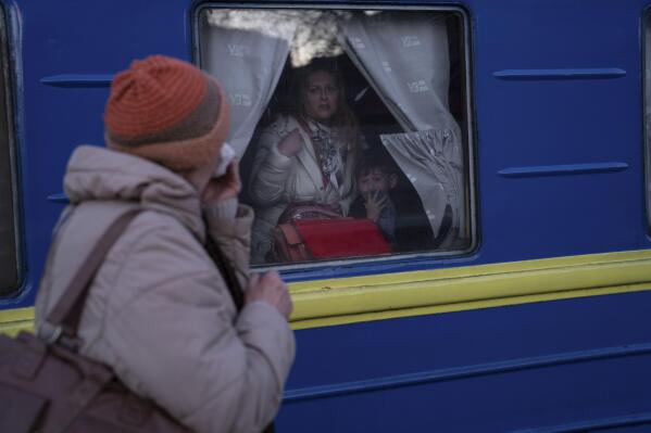 Ludmila, left, says goodbye to her granddaughter Kristina, who with her son Yaric, leave the train station in Odesa, southern Ukraine, on Tuesday, March 22, 2022. The U.N. refugee agency says more than 3.5 million people have fled Ukraine since Russia's invasion. (AP Photo/Petros Giannakouris)