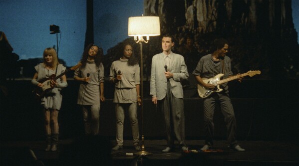 This image released by A24 shows, from left, Tina Weymouth, Ednah Holt, Lynn Mabry, David Byrne, Alex Weir in a scene from "Stop Making Sense." (Jordan Cronenweth/A24 via AP)