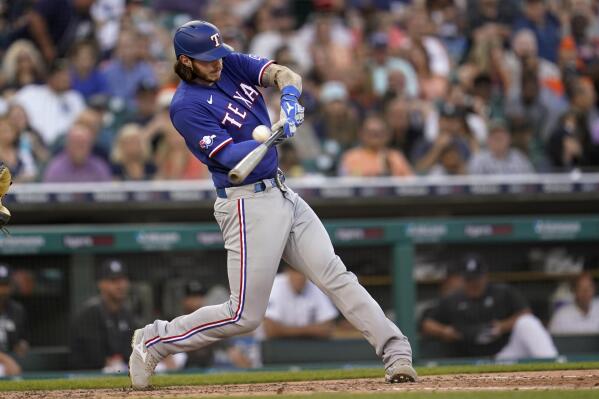 Texas Rangers' Jonah Heim hits a home run against the Detroit Tigers in the fifth inning of a baseball game in Detroit, Friday, June 17, 2022. (AP Photo/Paul Sancya)