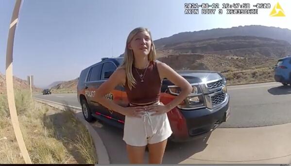 This police camera video provided by The Moab Police Department shows Gabrielle “Gabby” Petito talking to a police officer after police pulled over the van she was traveling in with her boyfriend, Brian Laundrie, near the entrance to Arches National Park on Aug. 12, 2021. The couple was pulled over while they were having an emotional fight. Petito was reported missing by her family a month later and is now the subject of a nationwide search. (The Moab Police Department via AP)
