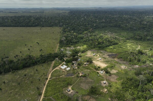 The Linha 26 Indigenous Wari' community, lies next to a deforested area in Nova Mamore, Rondonia state, Brazil, Friday, July 14, 2023. On June 6, about 60 armed men invaded the village, expelling its inhabitants. They only returned after the Federal Police went to the locale and retook it, according to the Wari’ umbrella organization. (AP Photo/Andre Penner)