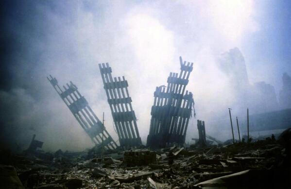 The remains of the World Trade Center stands amid the debris in New York, Tuesday, Sept. 11, 2001. (AP Photo/Alexandre Fuchs)