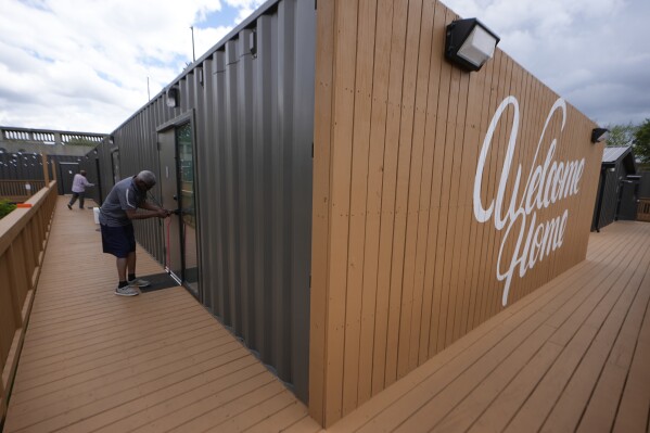 Melody resident Otis Johnson walks from his apartment Friday, April 12, 2024, in Atlanta. The Melody is a housing complex made from shipping containers and is intended to help house people from Atlanta's homeless population. (AP Photo/John Bazemore)