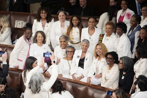 Women members of the House of Representatives, pose for photos before President Joe Biden arrives to deliver his State of the Union address to a joint session of Congress, at the Capitol in Washington, Thursday, March 7, 2024. (AP Photo/J. Scott Applewhite)