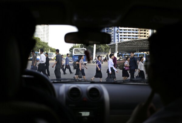 
              People cross a street in Pyongyang, North Korea, Tuesday, June 12, 2018. President Donald Trump and North Korea's Kim Jong Un concluded an extraordinary nuclear summit Tuesday with the U.S. president pledging unspecified "security guarantees" to the North and Kim recommitting to the "complete denuclearization of the Korean Peninsula." (AP Photo/Dita Alangkara)
            