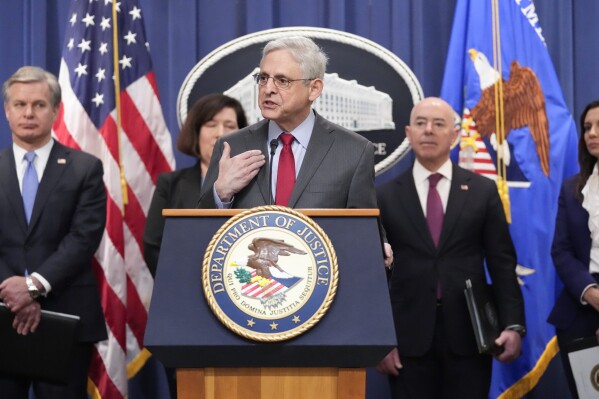 Attorney General Merrick Garland speaks with reporters during a news conference at the Department of Justice, Wednesday, Dec. 6, 2023, in Washington, with from left, FBI Director Christopher Wray, Senior Official Performing the Duties of the Deputy Director Staci Barrera, of U.S. Immigration and Customs Enforcement, Secretary of Homeland Security Alejandro Mayorkas and Assistant Attorney General Nicole M. Argentieri of the Criminal Division. (AP Photo/Mark Schiefelbein)