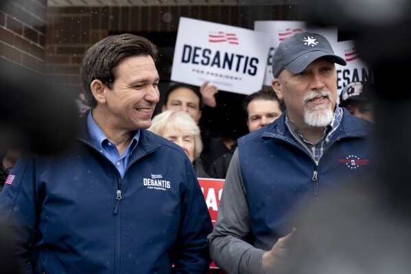Republican presidential candidate Florida Gov. Ron DeSantis and Rep. Chip Roy, R-Texas, speak to members of the media outside his campaign office in Urbandale, Iowa, Friday, Jan. 12, 2024. (AP Photo/Andrew Harnik)