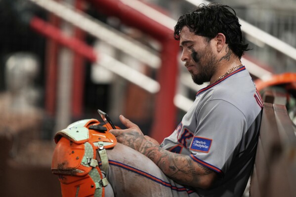 New York Mets catcher Francisco Alvarez (4) in the dugout after a loss to the Atlanta Braves after a baseball game, Tuesday, June 17, 2025, in Atlanta. (AP Photo/Brynn Anderson)