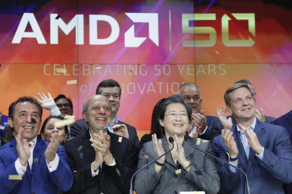 FILE - In this May 1, 2019, file photo, Lisa Su, second from right, president and CEO of AMD, attends the opening bell at Nasdaq to celebrate its 50th anniversary in New York. AMD is buying processing platform developer Xilinx in an all-stock deal valued at $35 billion. (AP Photo/Mark Lennihan)