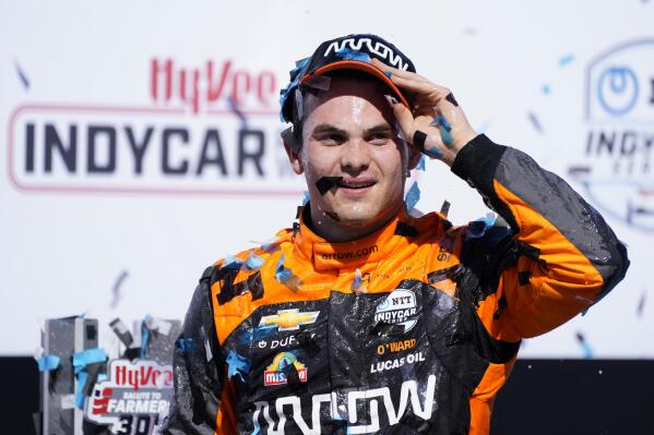 Pato O'Ward, of Mexico, celebrates after winning an IndyCar Series auto race, Sunday, July 24, 2022, at Iowa Speedway in Newton, Iowa. (AP Photo/Charlie Neibergall)
