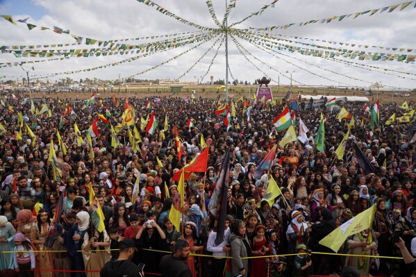 Syrian Kurds gather to celebrate their Nowruz, Kurdish New Year, in Qamishli, northeastern Syria, Friday March 21, 2025. (AP Photo/Baderkhan Ahmad)