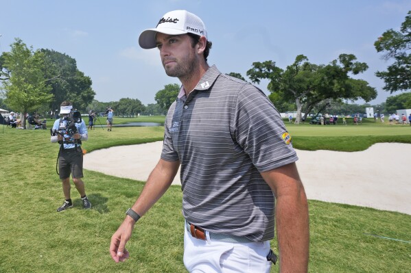Davis Riley walks from the ninth hole during the third round of the Charles Schwab Challenge golf tournament at Colonial Country Club in Fort Worth, Texas, Saturday, May 25, 2024. (AP Photo/LM Otero)